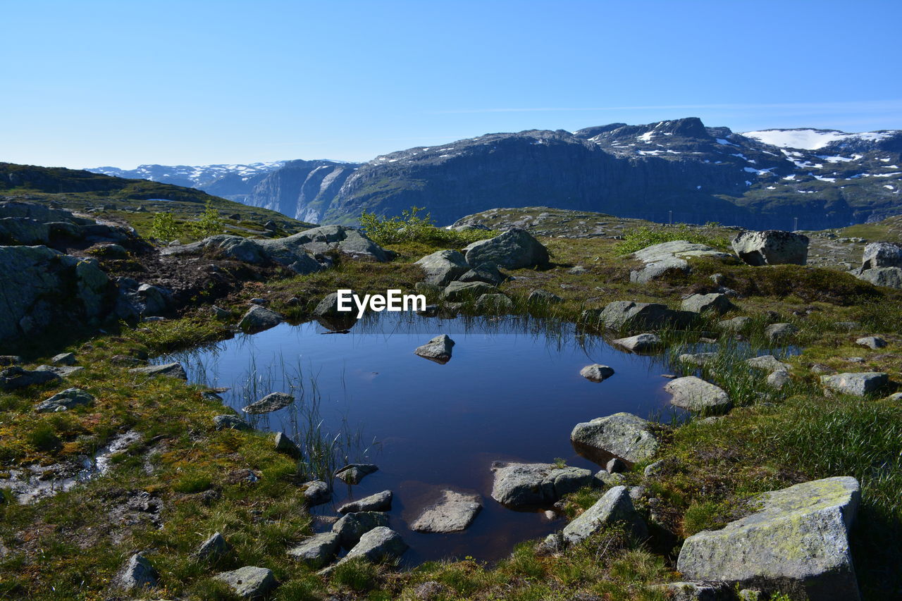 Scenic view of mountains against clear blue sky