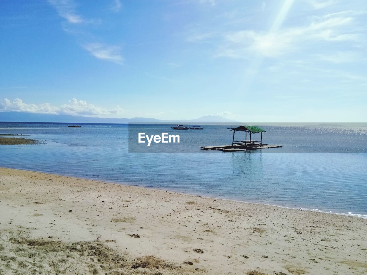 MAN IN SEA AGAINST SKY