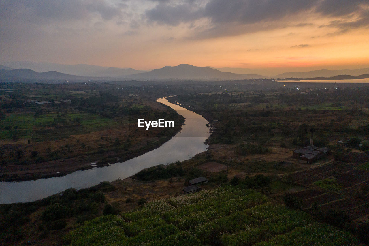 Scenic view of river against sky during sunset