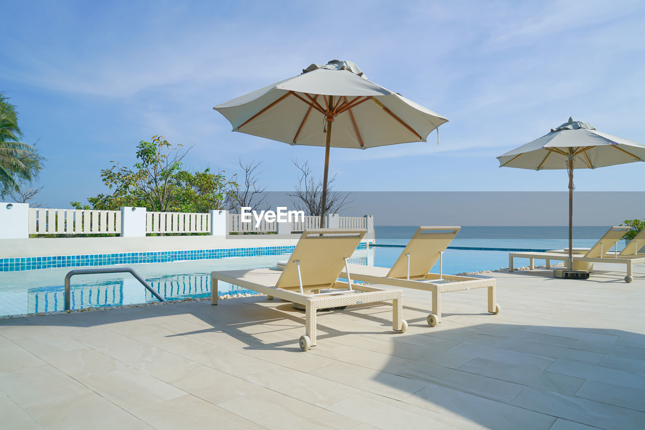 deck chairs and lounge chair at beach