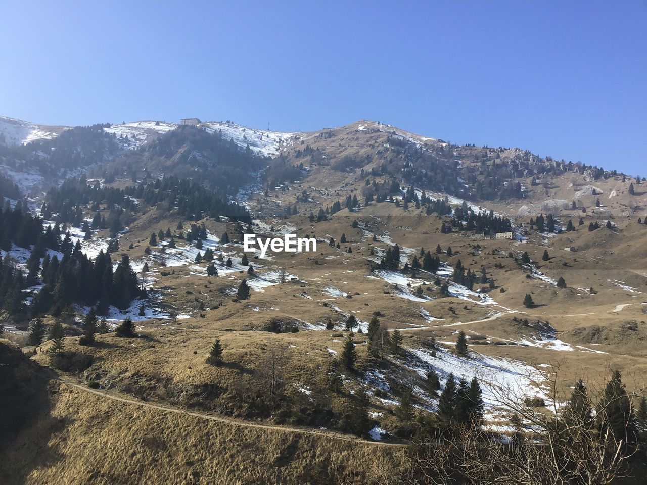 Scenic view of snowcapped mountains against clear blue sky