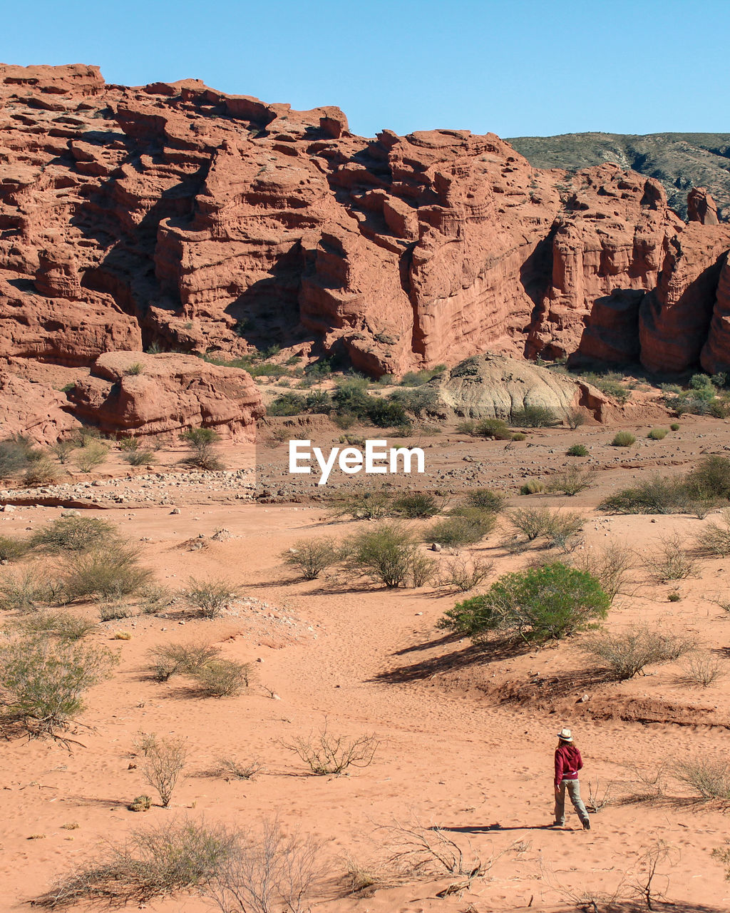 Full length of man on rock formations in desert