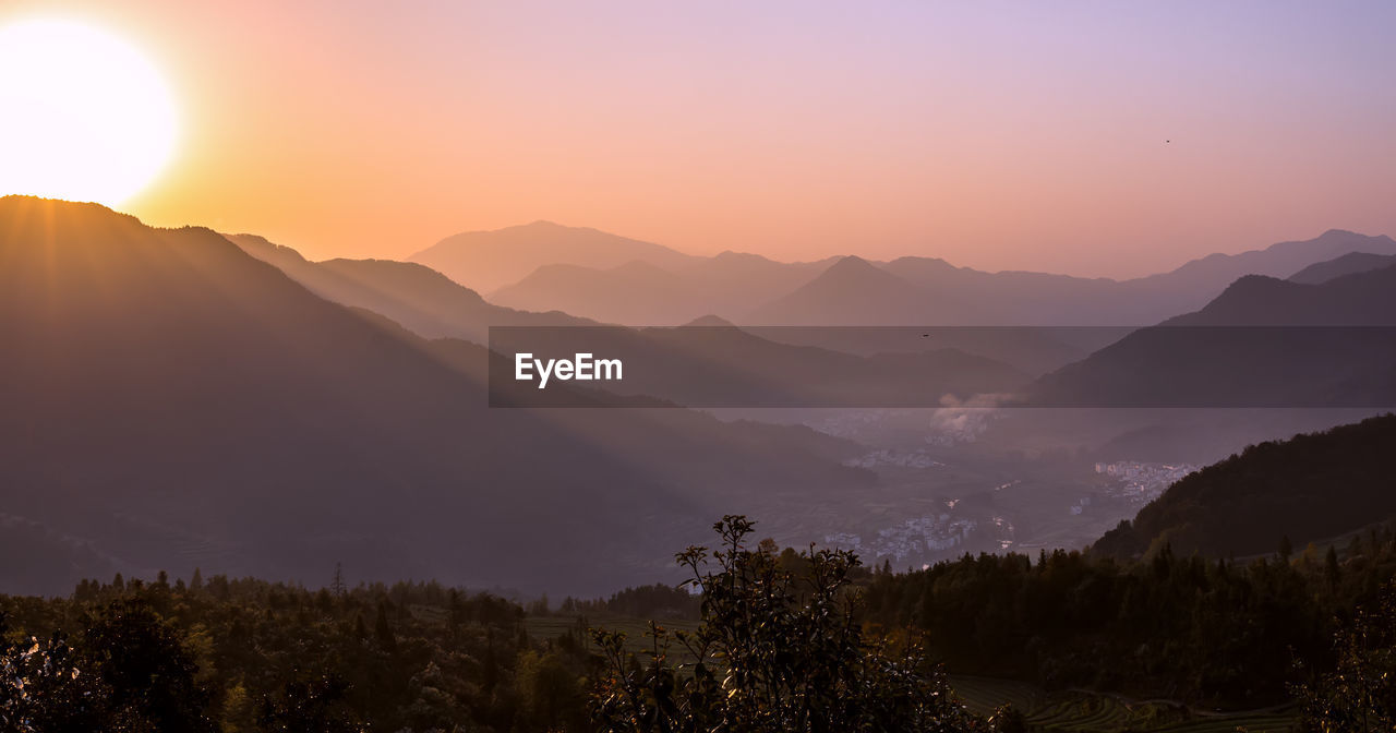 Scenic view of mountains against sky during sunset