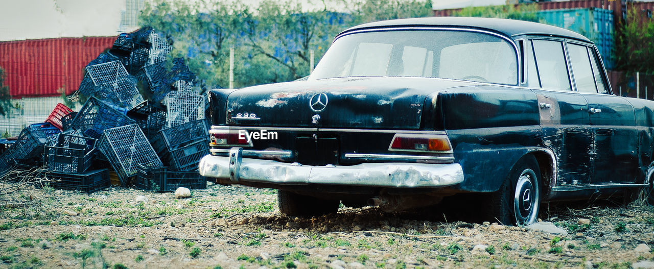 ABANDONED CAR ON FIELD