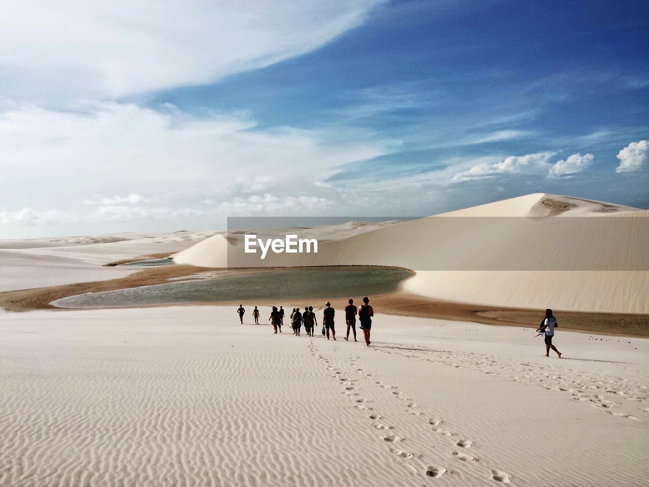 People walking on sand dune in desert