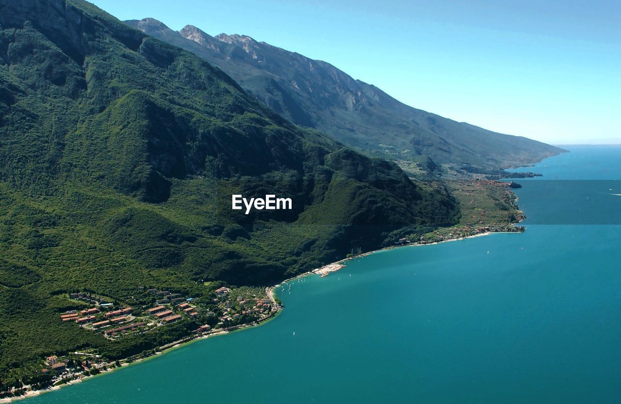 High angle view of lake garda and mountains against sky