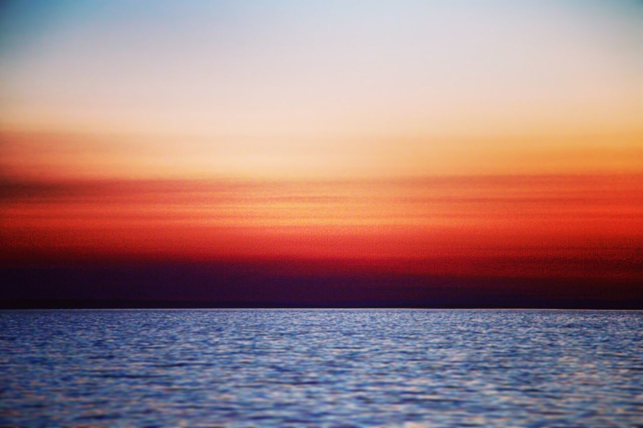 SCENIC VIEW OF CALM SEA DURING SUNSET