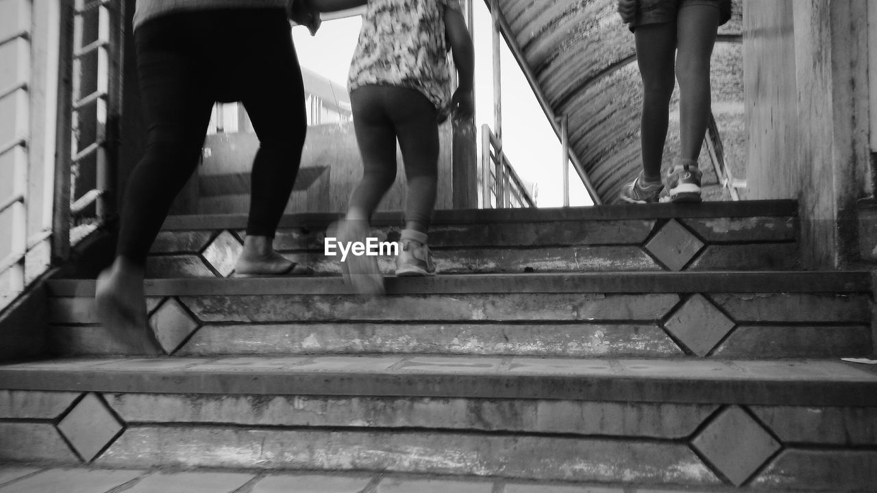 Low section of people standing on steps