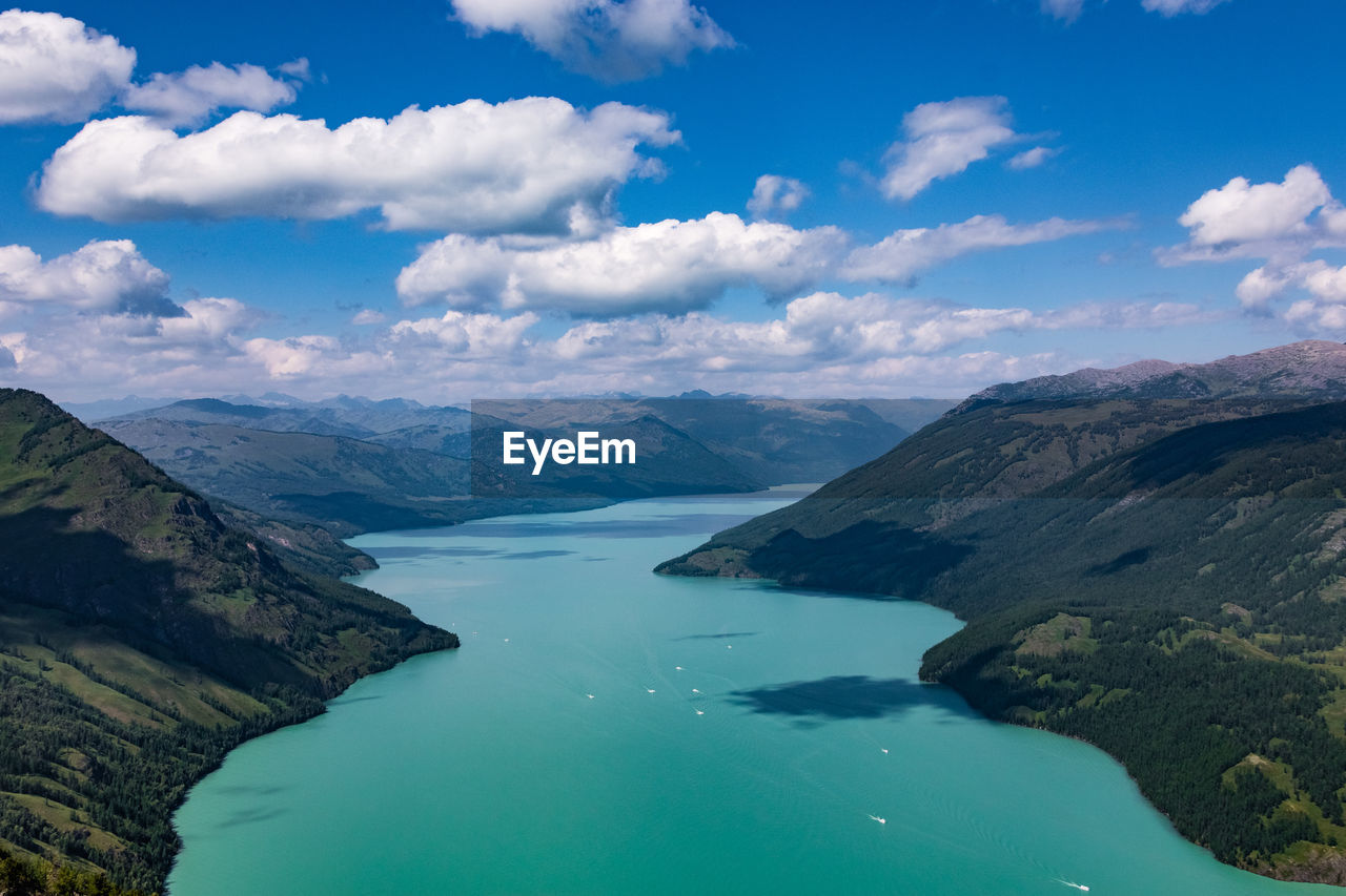 Aerial view of lake in between mountains