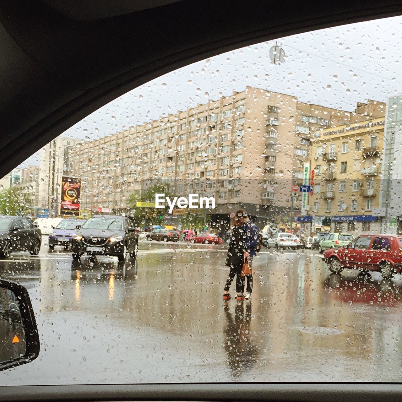 Vehicles at road on a rainy day