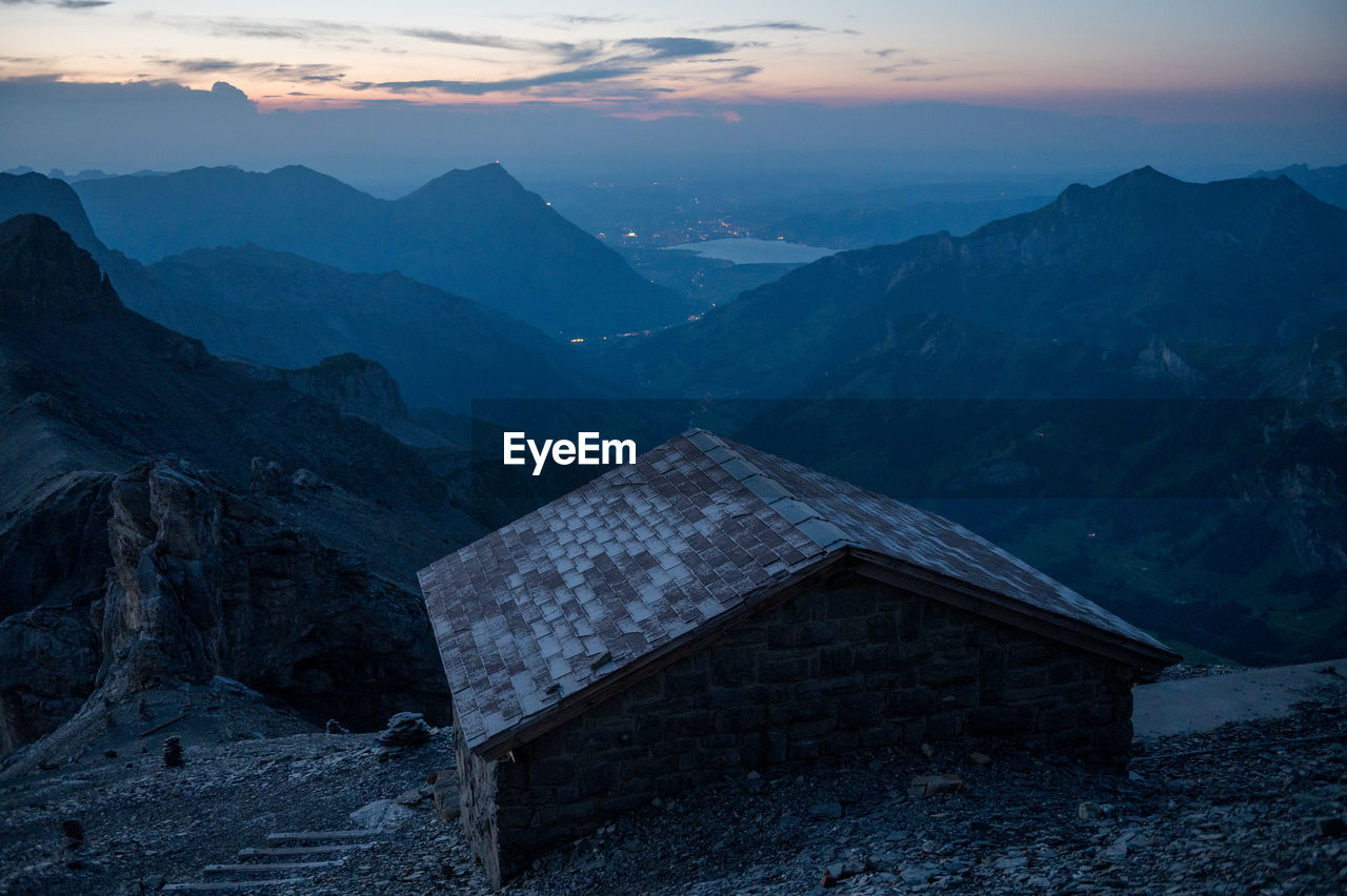 SCENIC VIEW OF MOUNTAINS AGAINST SKY AT SUNSET