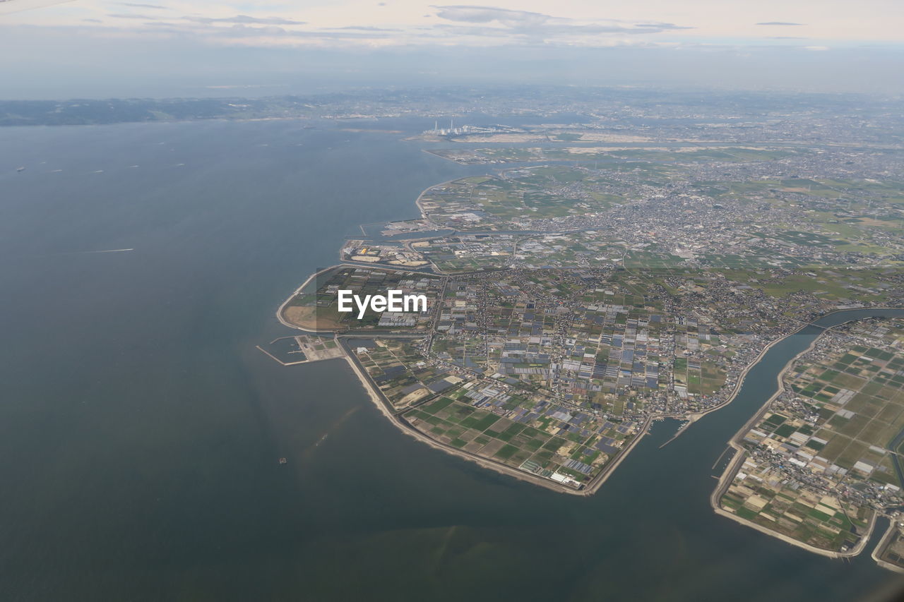 Aerial view of buildings and sea against sky