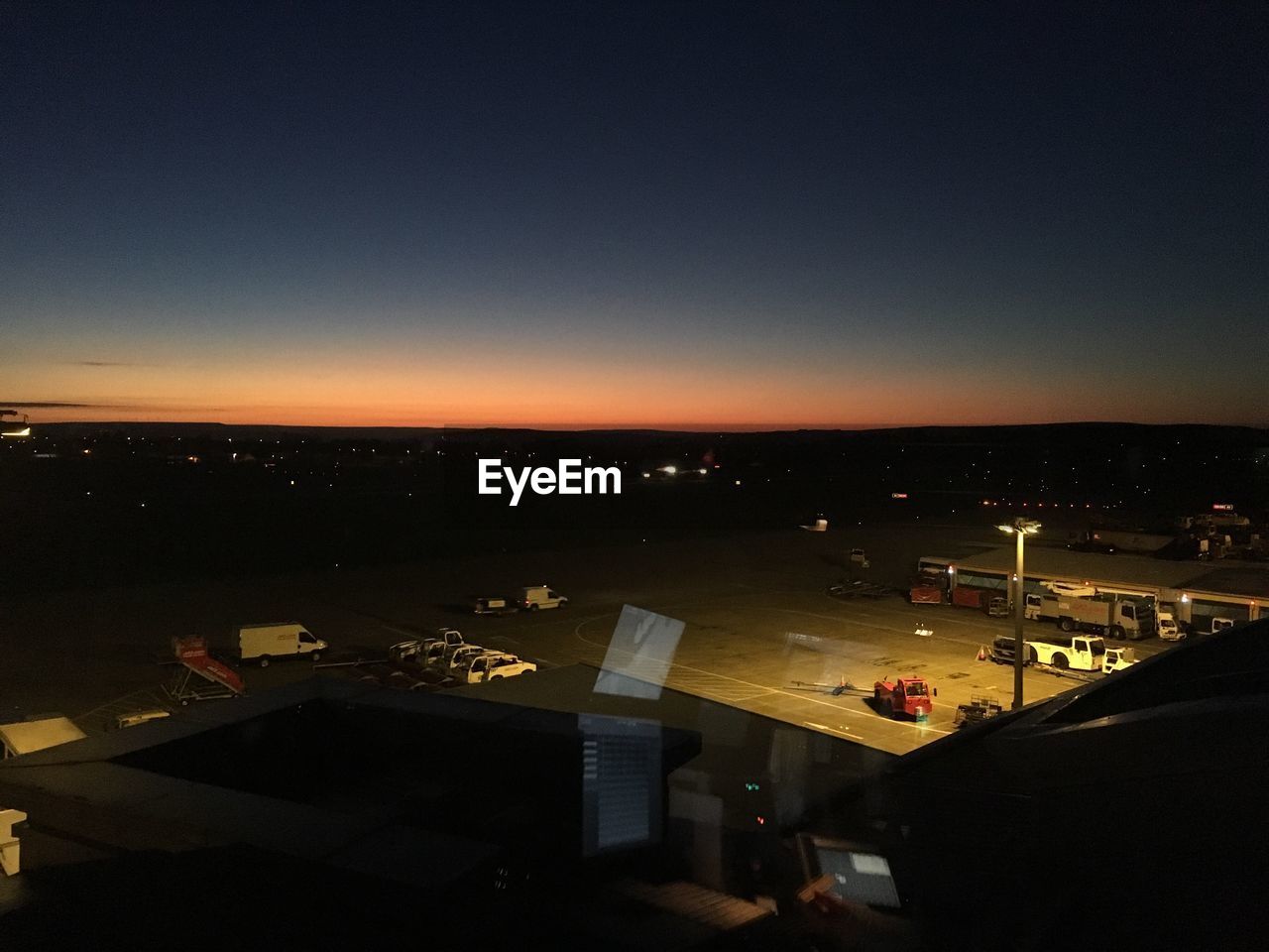 HIGH ANGLE VIEW OF ILLUMINATED CITY AGAINST SKY