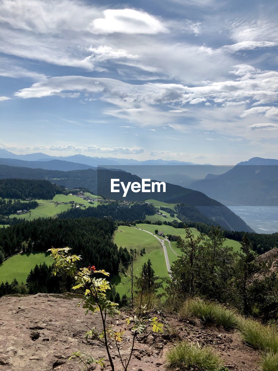 SCENIC VIEW OF TREES AND MOUNTAINS AGAINST SKY