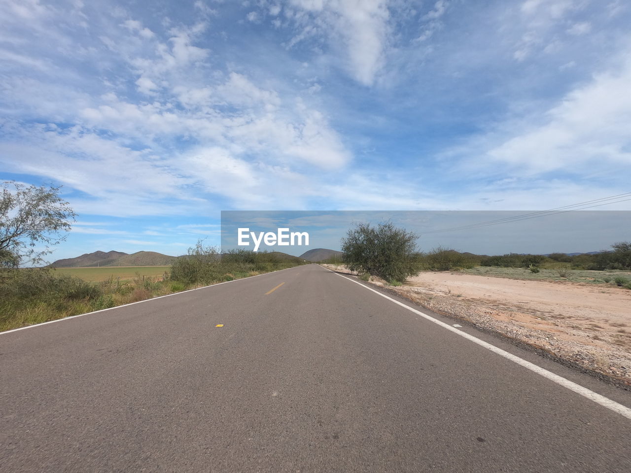 EMPTY ROAD AGAINST SKY