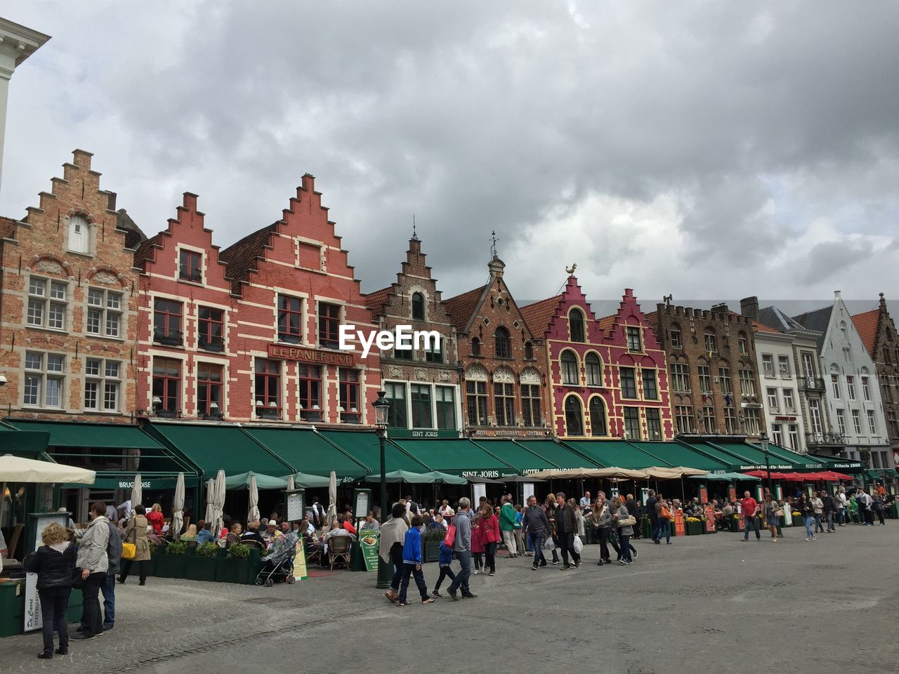 Houses at grote markt against cloudy sky