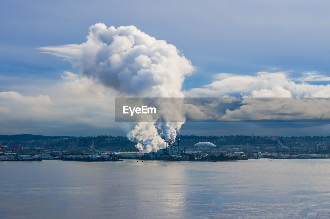 Steam rises from a factory near the port of tacoma.