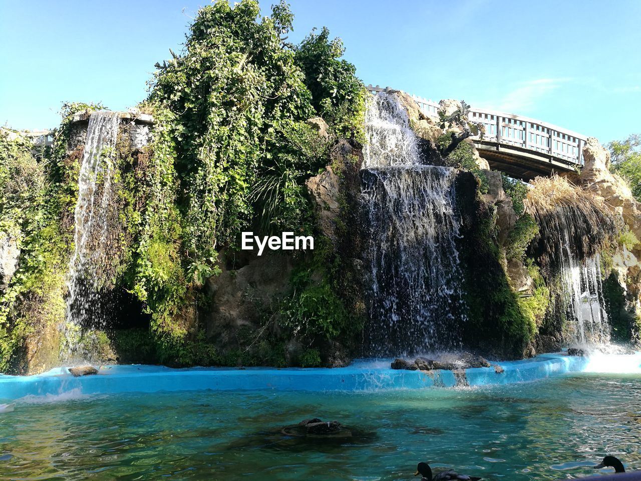 SCENIC VIEW OF WATERFALL ON CLIFF