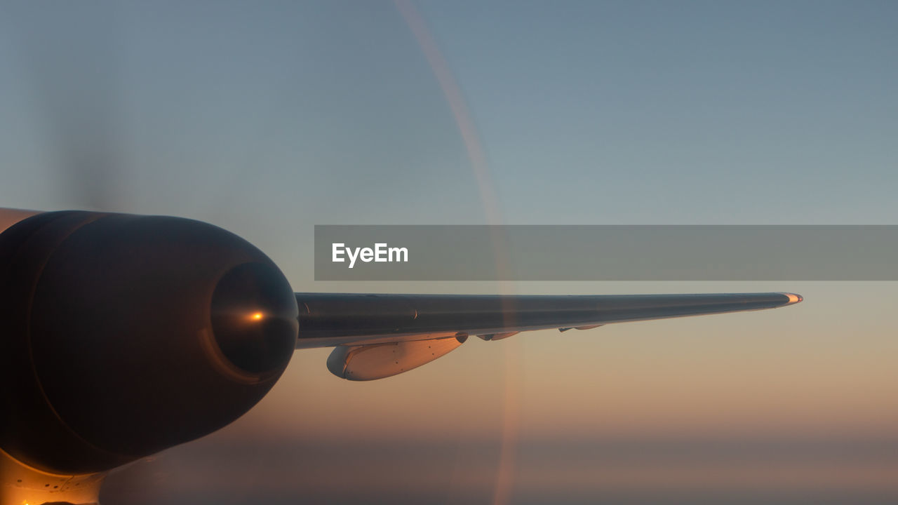 Close-up of propeller against sky at sunset