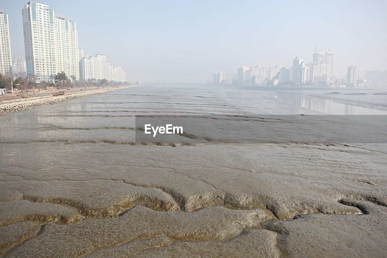 SCENIC VIEW OF BEACH AND BUILDINGS AGAINST SKY