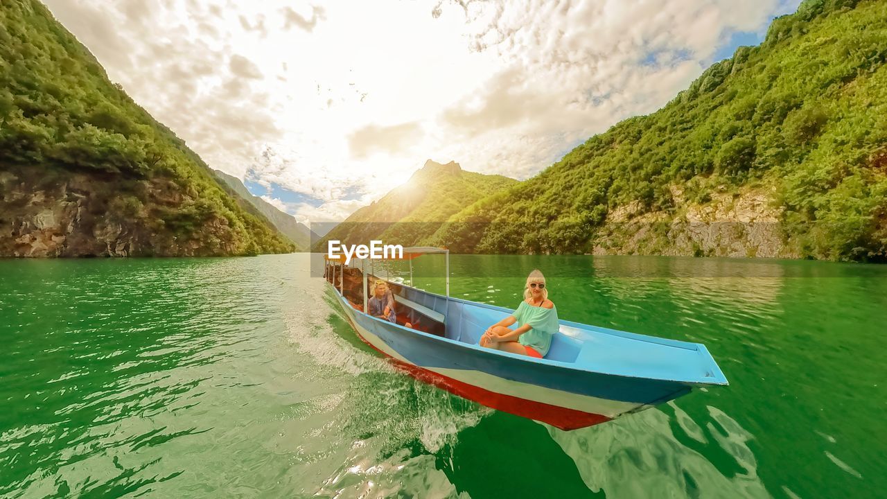 rear view of man kayaking in lake