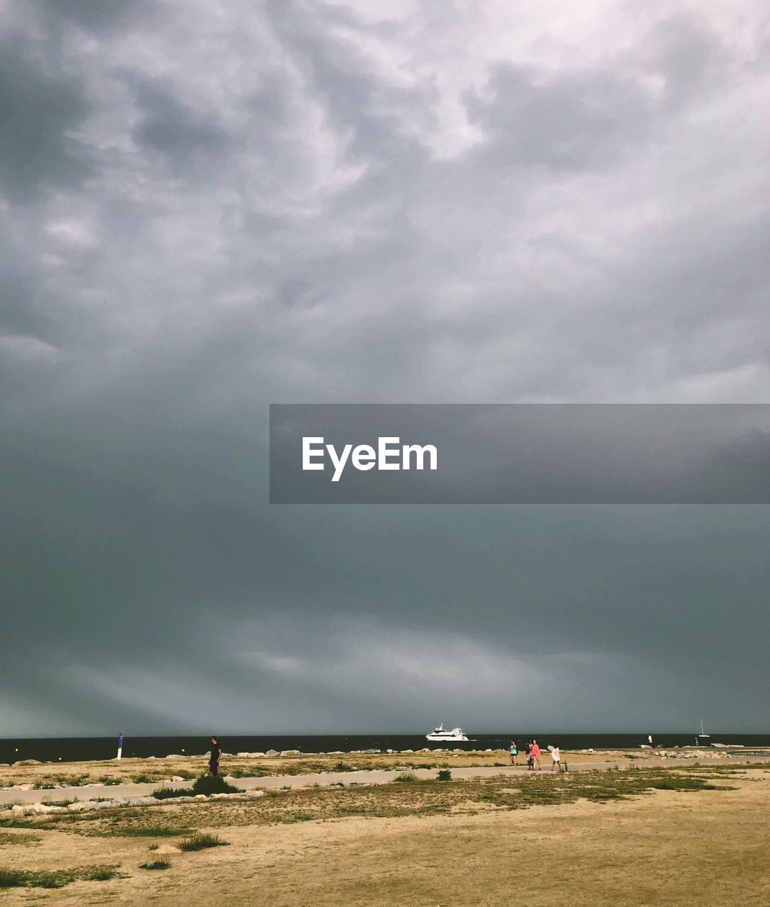 Scenic view of field against cloudy sky