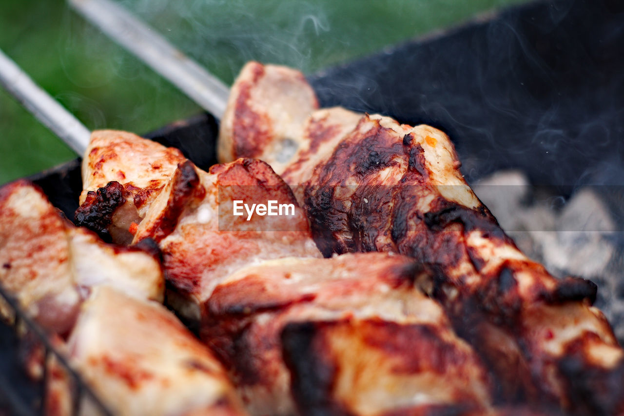 High angle view of meat on barbecue grill