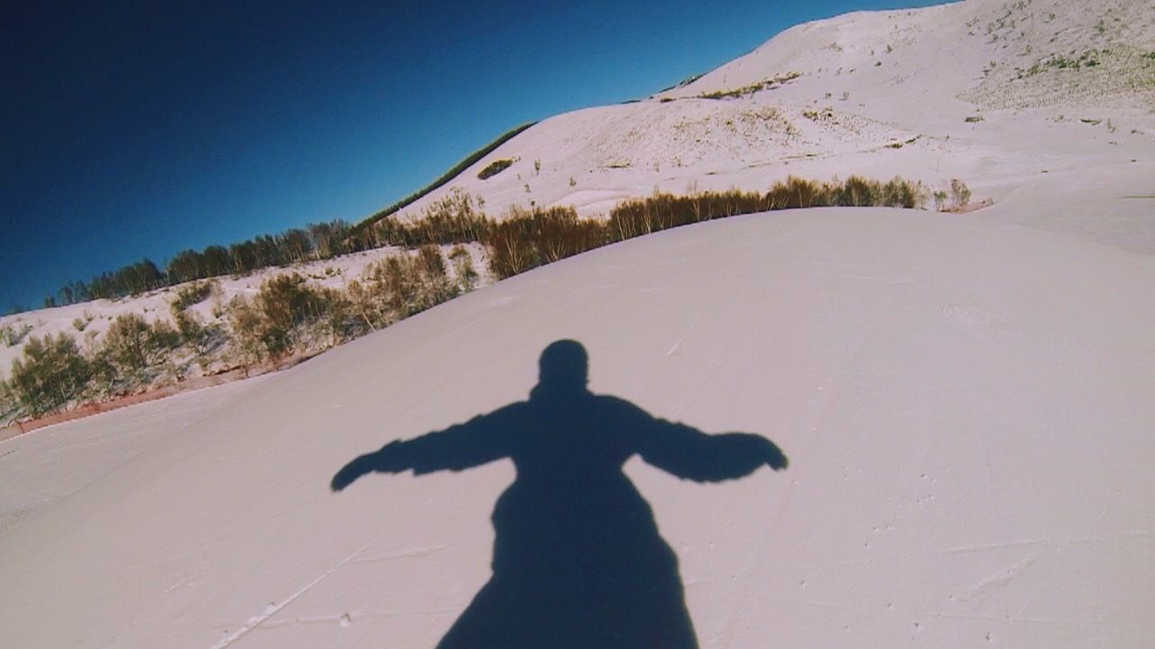 SHADOW OF PERSON ON ROCK