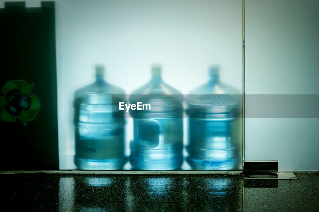 Plastic water containers seen through glass