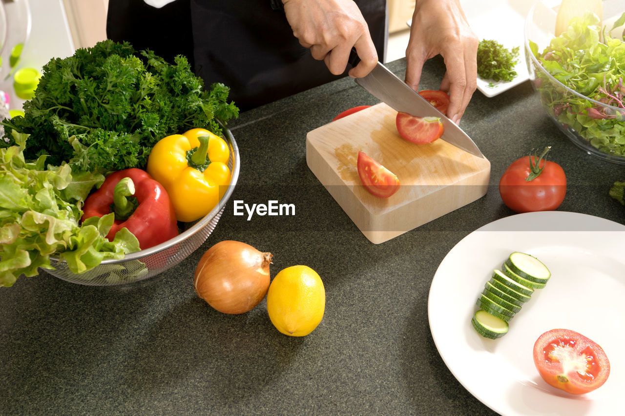 HIGH ANGLE VIEW OF SALAD AND VEGETABLES ON TABLE