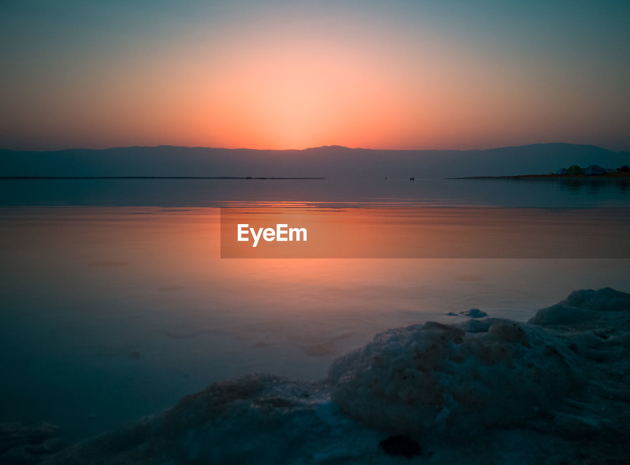 Scenic view of sea against sky during sunrise 