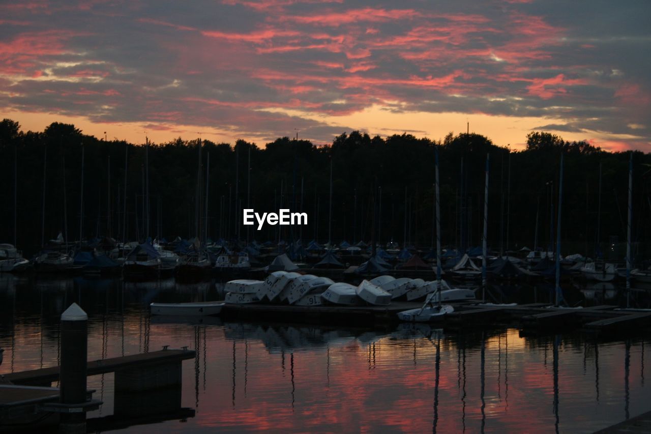 SAILBOATS MOORED AT HARBOR