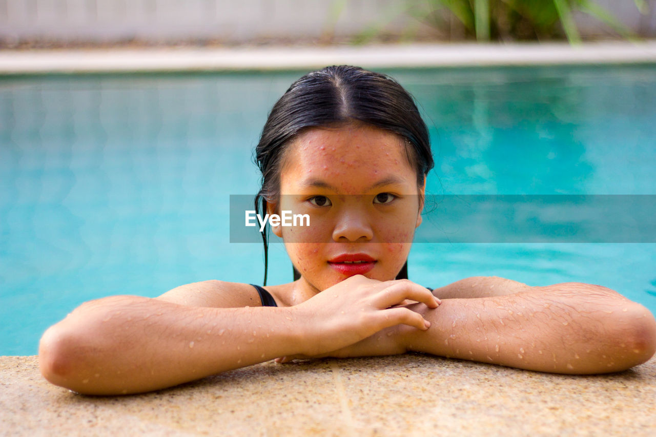 Portrait of asian woman standing on the edge of pool