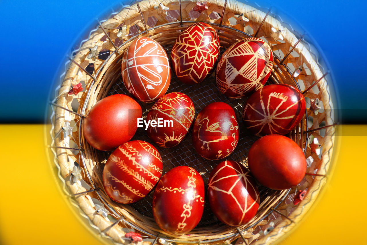 Basket of red eggs, easter holiday concept. painted eggs, pysanka or krashanka. ukraine flag. 