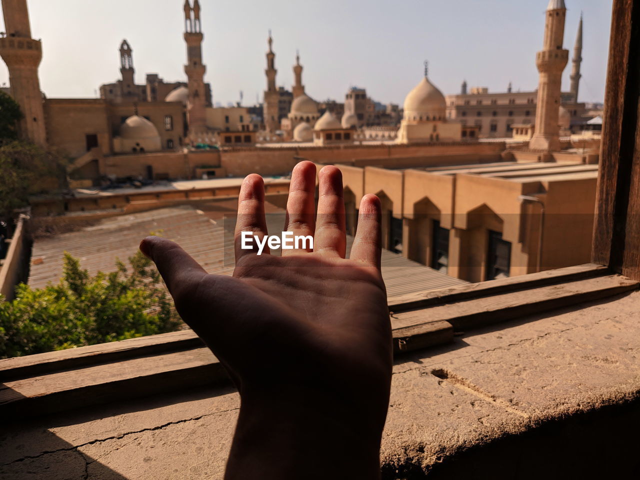 Hand through a window and light