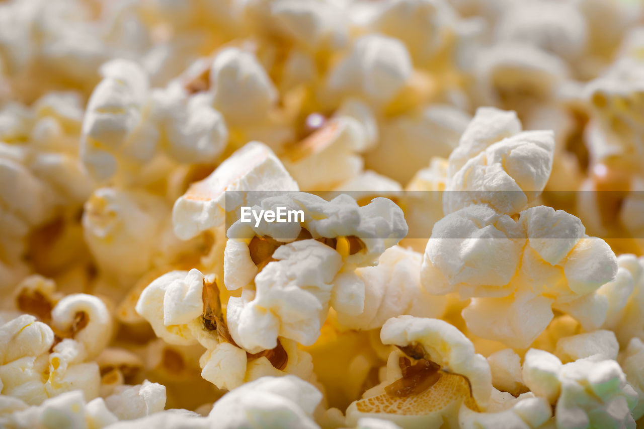 Pile of popcorn closeup macro shot, selective focus, texture background