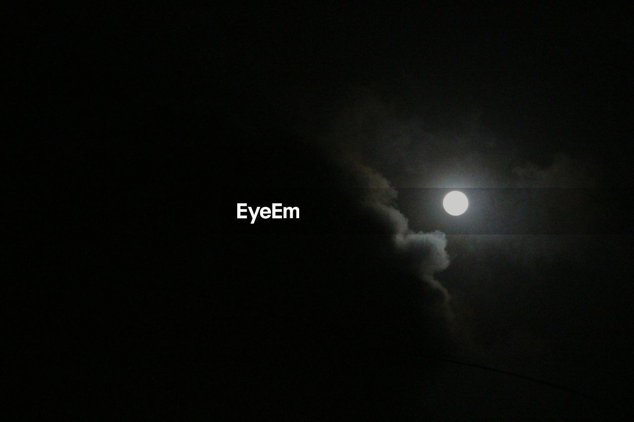 LOW ANGLE VIEW OF MOON IN SKY AT NIGHT