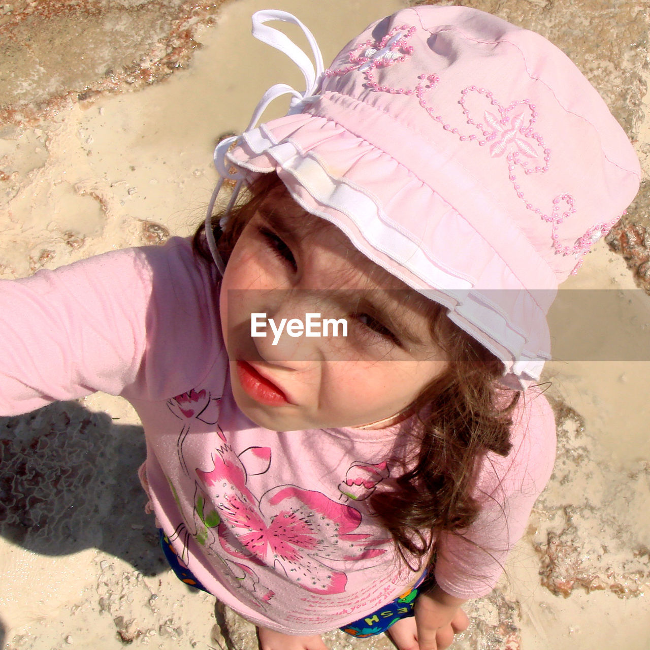 CLOSE-UP PORTRAIT OF GIRL STANDING ON SAND