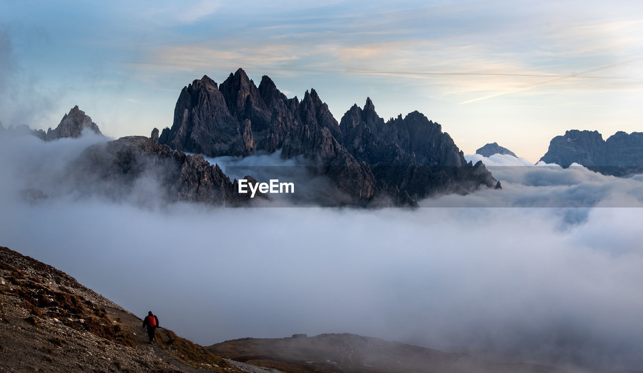 Rear view of man on mountains against sky