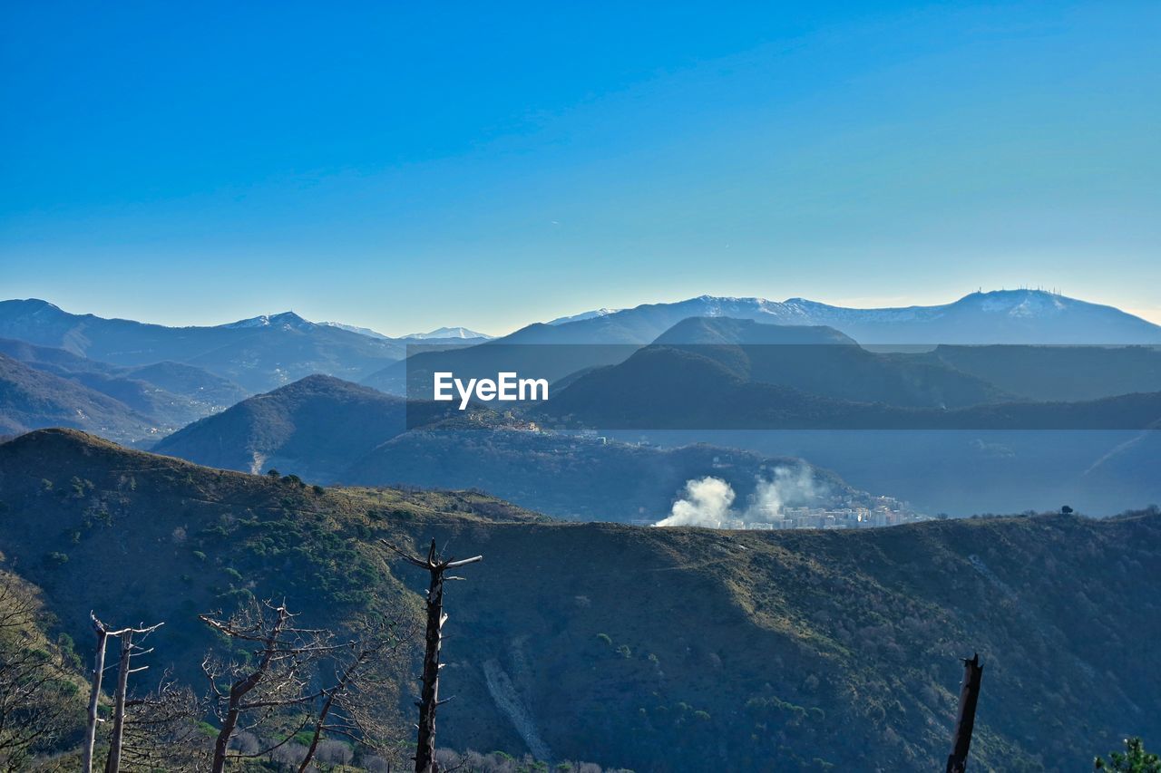 PANORAMIC VIEW OF MOUNTAINS AGAINST BLUE SKY