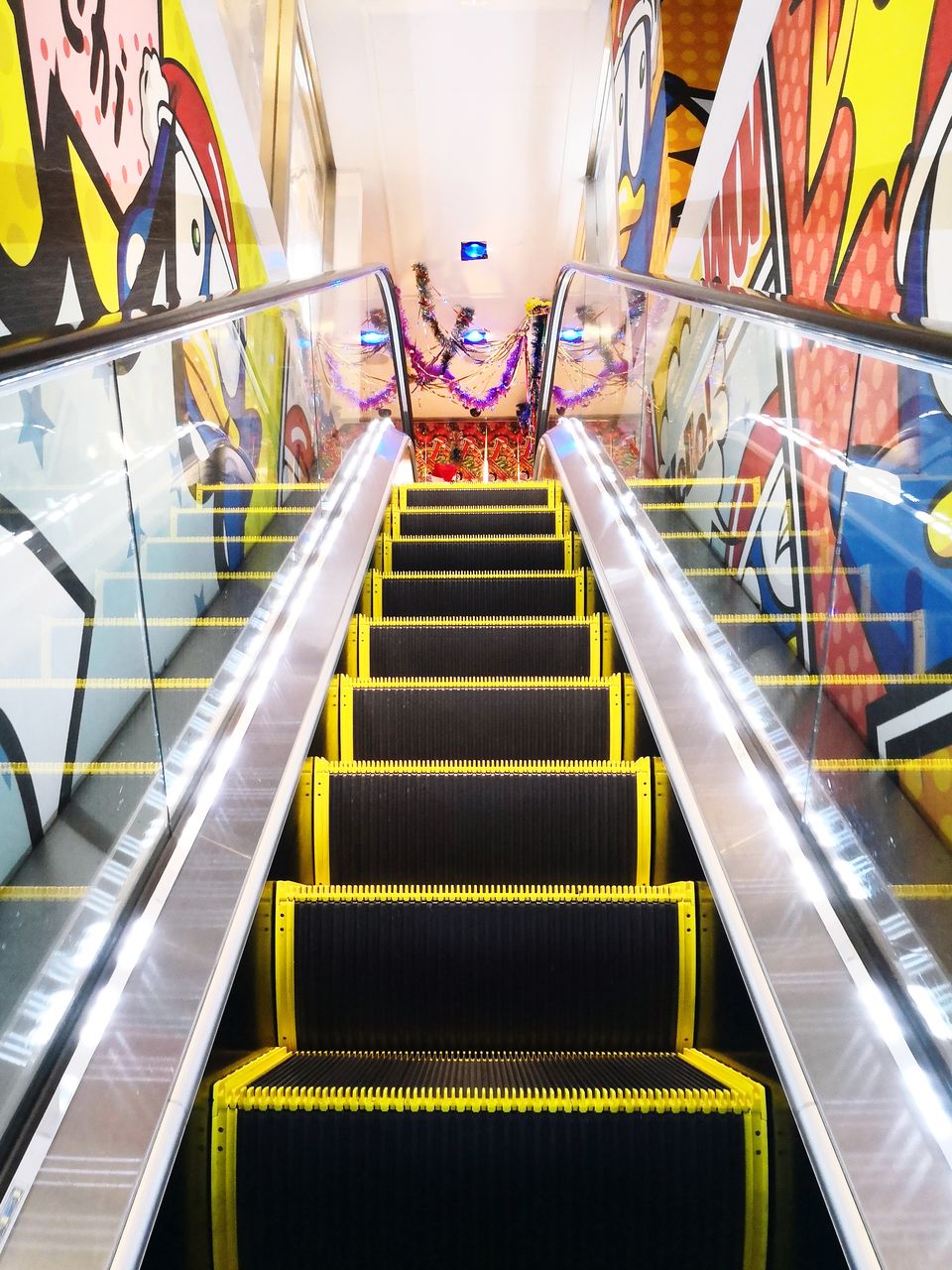 LOW ANGLE VIEW OF ESCALATORS