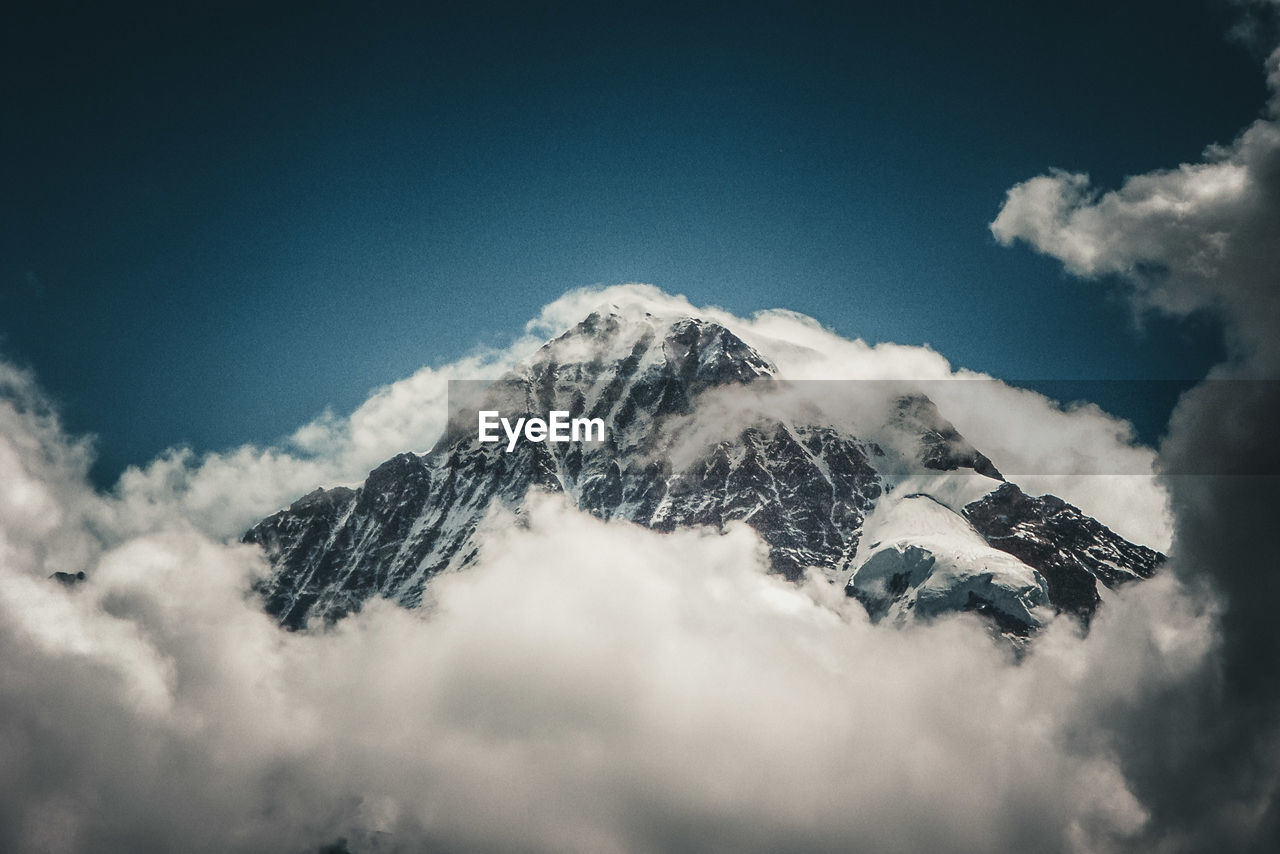 Low angle view of snowcapped mountain against sky