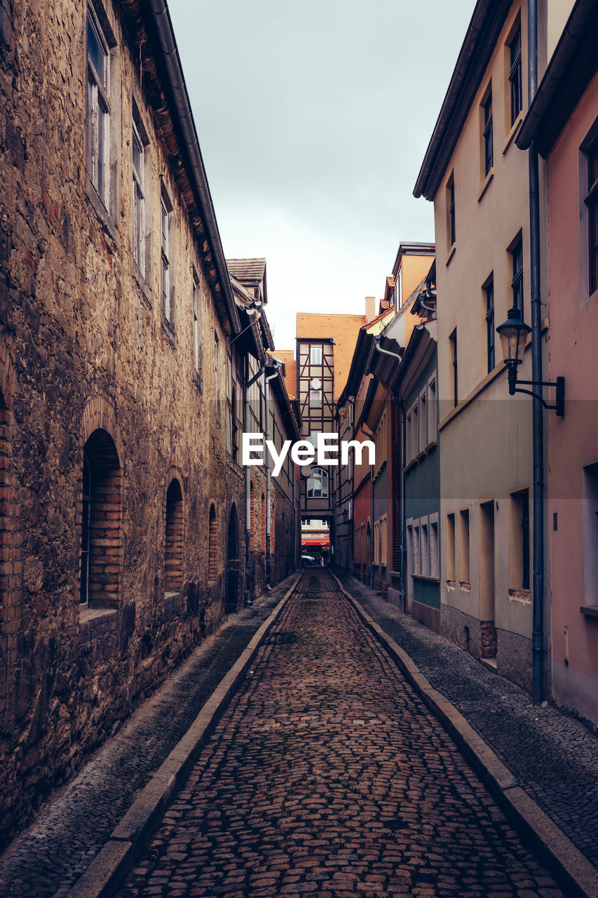 Narrow street amidst buildings in city