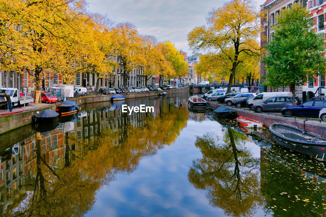 Boats moored in canal during autumn