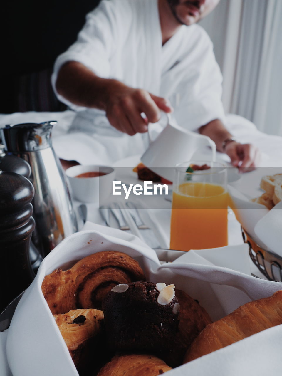 Midsection of man having breakfast at home