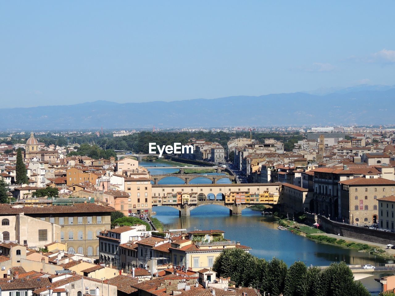 HIGH ANGLE VIEW OF RIVER BY BUILDINGS AGAINST SKY