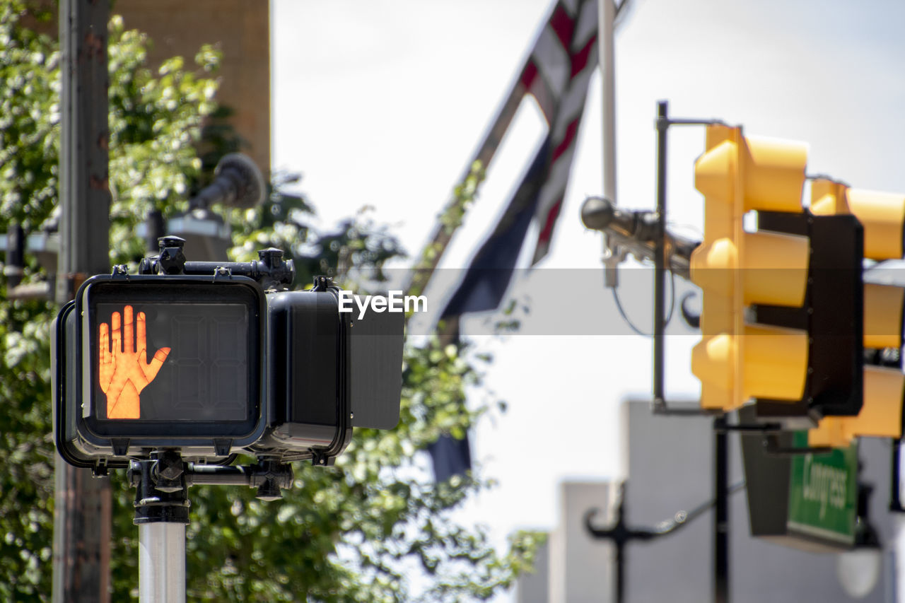 LOW ANGLE VIEW OF CAMERA AND TELEPHONE POLE