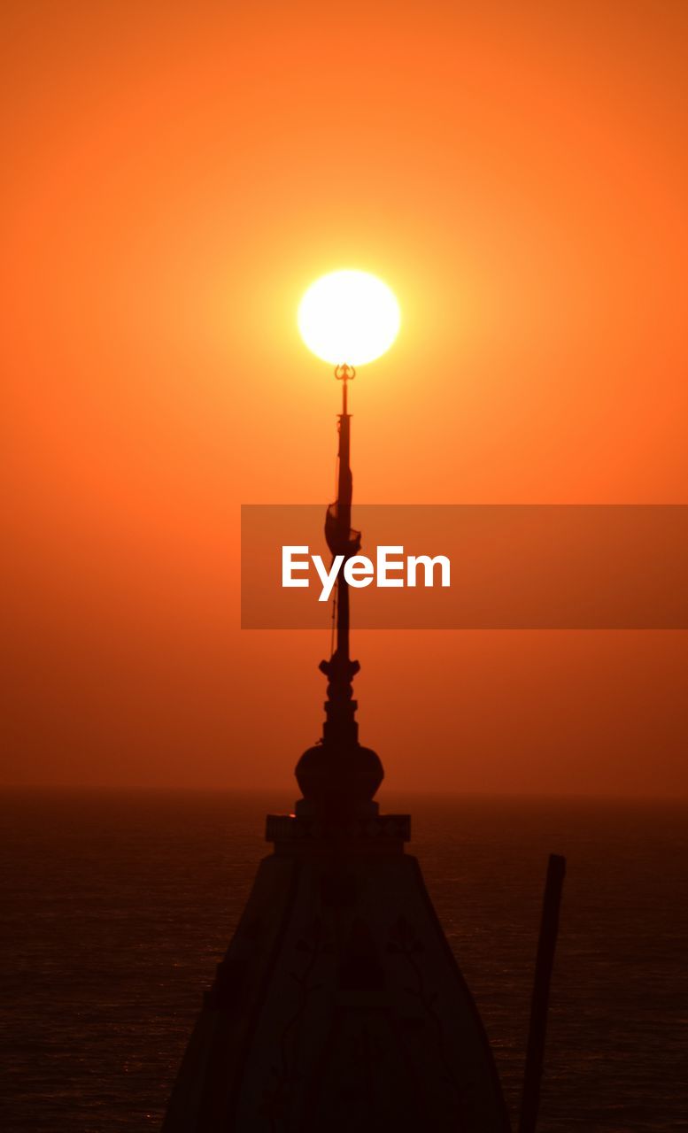 Silhouette of temple against clear sky at sunset