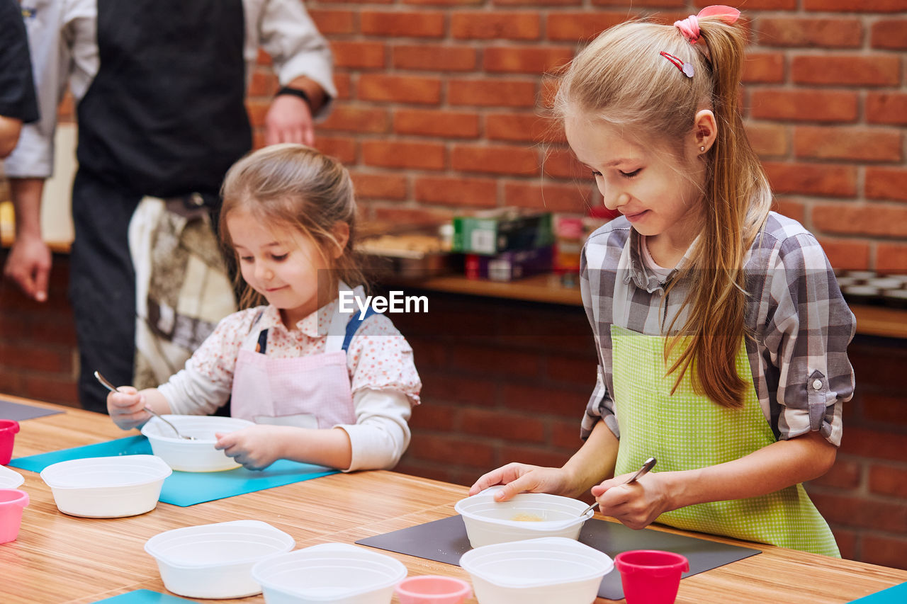 Girls learning cooking in class