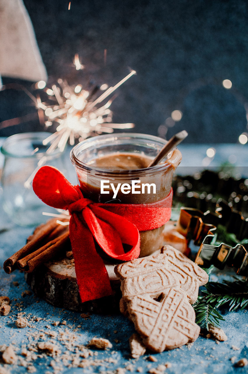 High angle view of hot chocolate with cookie with tied ribbon on table